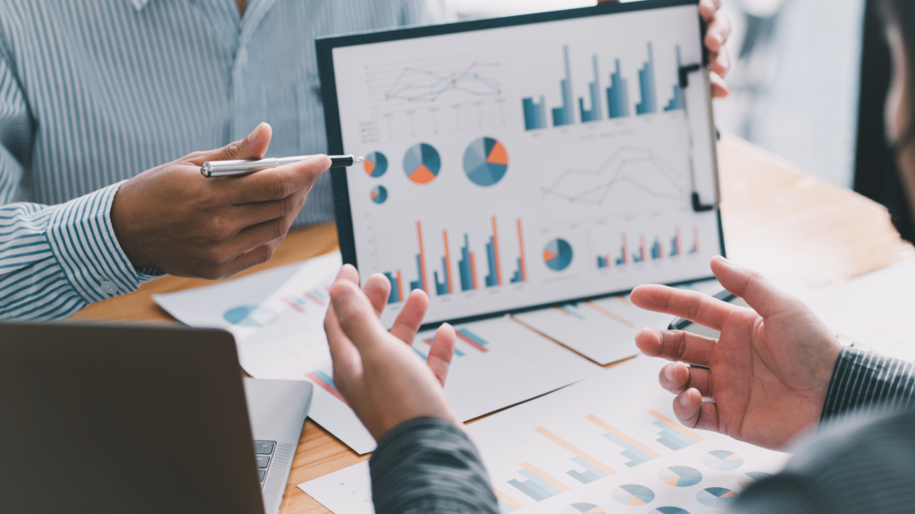 Team reviewing dashboard data to improve revenue predictability and forecasting accuracy